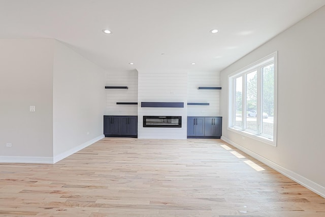 7948 W 74th Ave, Bridgeview, IL 60455 - unfurnished living room featuring light wood-style flooring, recessed lighting, and a fireplace
