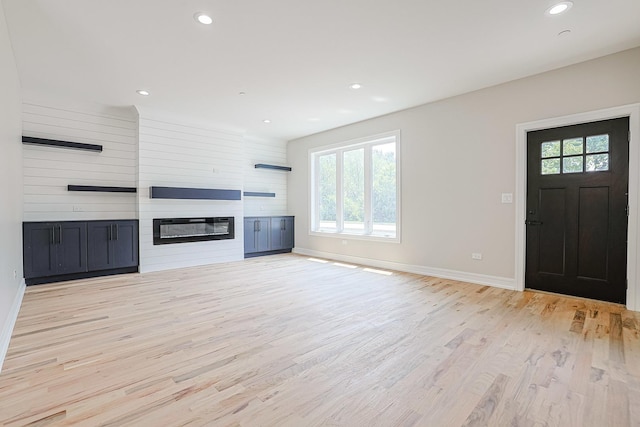 7948 W 74th Ave, Bridgeview, IL 60455 - unfurnished living room with plenty of natural light, light wood-style flooring, recessed lighting, and a large fireplace