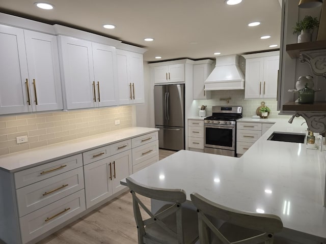 1530 Laurel Oaks Dr, Streamwood, IL 60107 - kitchen featuring appliances with stainless steel finishes, premium range hood, decorative backsplash, recessed lighting, and a kitchen breakfast bar