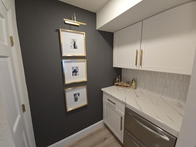 1530 Laurel Oaks Dr, Streamwood, IL 60107 - kitchen featuring tasteful backsplash, white cabinets, light stone countertops, and light wood-type flooring