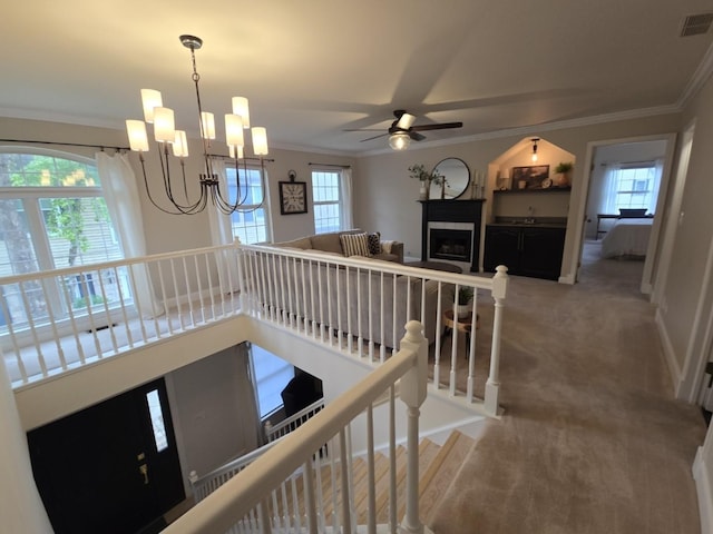 1530 Laurel Oaks Dr, Streamwood, IL 60107 - stairs featuring ornamental molding, a ceiling fan, plenty of natural light, a fireplace, and a chandelier