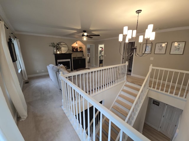 1530 Laurel Oaks Dr, Streamwood, IL 60107 - stairs with a chandelier, ornamental molding, a ceiling fan, and a tiled fireplace