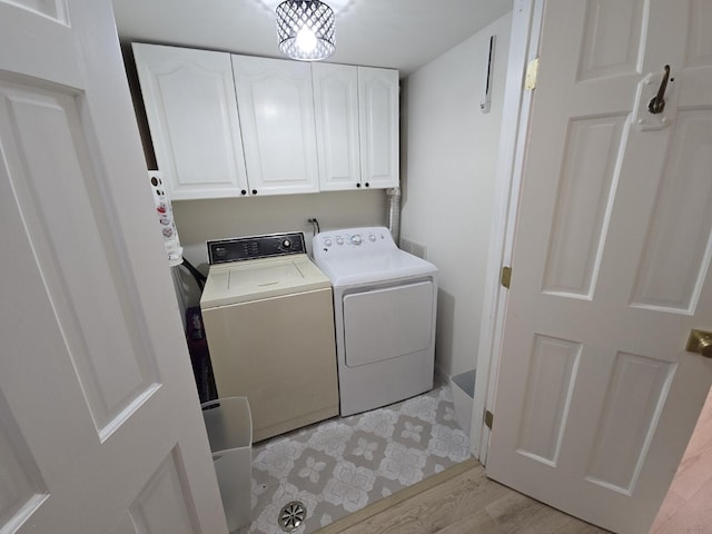 1530 Laurel Oaks Dr, Streamwood, IL 60107 - washroom featuring cabinet space, washing machine and dryer, and light wood-style flooring
