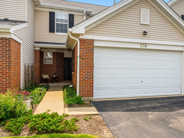 638 Legend Ln, Mchenry, IL 60050 - view of front of property featuring brick siding, asphalt driveway, a garage, and roof with shingles