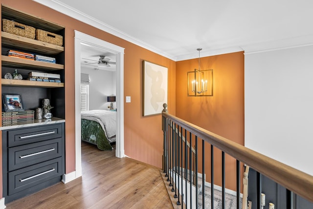 638 Legend Ln, Mchenry, IL 60050 - corridor featuring light wood-style flooring, a chandelier, ornamental molding, and an upstairs landing