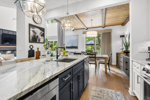 638 Legend Ln, Mchenry, IL 60050 - kitchen with a chandelier, stainless steel appliances, light stone counters, pendant lighting, and light wood-style floors