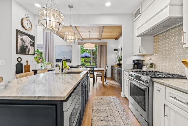 638 Legend Ln, Mchenry, IL 60050 - kitchen featuring appliances with stainless steel finishes, a chandelier, premium range hood, a wood ceiling with exposed beams, and a kitchen island with sink