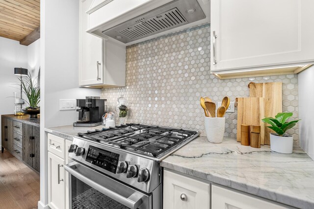 638 Legend Ln, Mchenry, IL 60050 - kitchen featuring stainless steel gas range oven, custom range hood, white cabinets, decorative backsplash, and wood ceiling