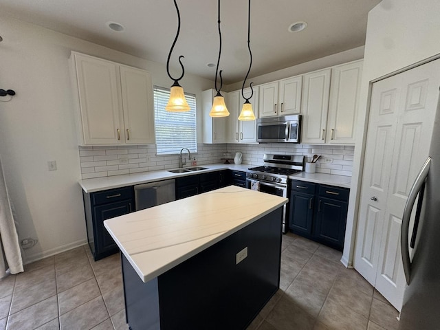 3122 Kyra Ln, Elgin, IL 60124 - kitchen featuring appliances with stainless steel finishes, tasteful backsplash, a center island, white cabinetry, and recessed lighting