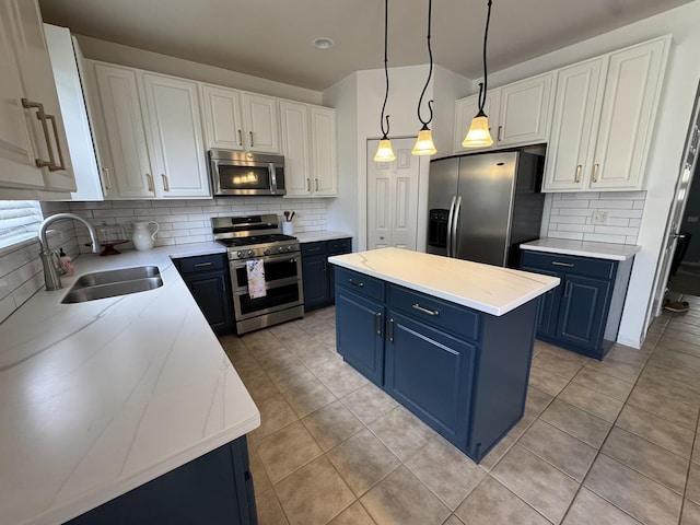 3122 Kyra Ln, Elgin, IL 60124 - kitchen with stainless steel appliances, blue cabinetry, tasteful backsplash, a kitchen island, and light tile patterned flooring