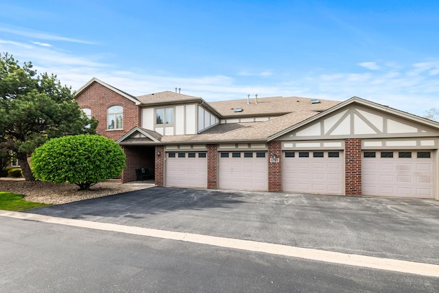 6248 Misty Pines Dr Unit 4, Tinley Park, IL 60477 - view of front facade with brick siding, driveway, and a shingled roof