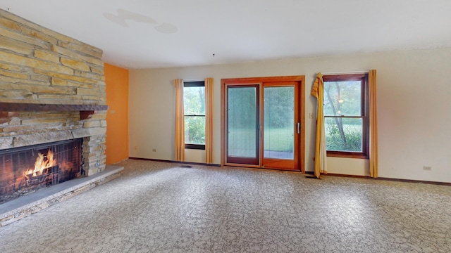198 S Circle Ave, Bloomingdale, IL 60108 - unfurnished living room featuring a stone fireplace and baseboards