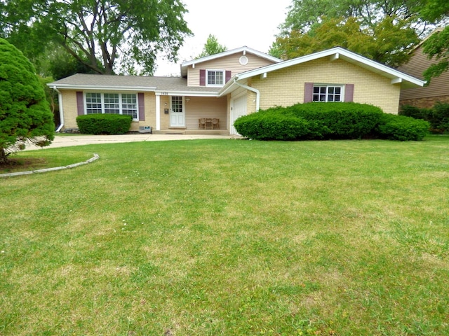 1420 E Lake Louise Dr, Palatine, IL 60074 - split level home featuring a garage, a front lawn, and brick siding