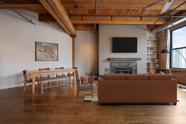 400 S Green St Unit 406, Chicago, IL 60607 - living area with a wooden ceiling with exposed beams, a fireplace, wood finished floors, a ceiling fan, and rail lighting