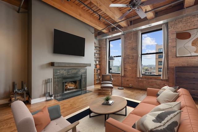 400 S Green St Unit 406, Chicago, IL 60607 - living area with a wood ceiling with exposed beams, brick wall, wood finished floors, a ceiling fan, and a tile fireplace