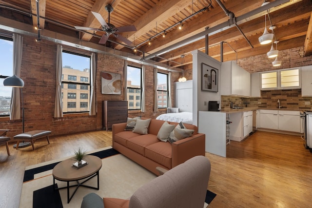 400 S Green St Unit 406, Chicago, IL 60607 - living room with light wood-style floors, brick wall, a wood ceiling with exposed beams, rail lighting, and a ceiling fan