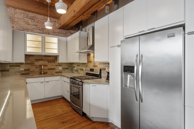 400 S Green St Unit 406, Chicago, IL 60607 - kitchen featuring appliances with stainless steel finishes, wall chimney range hood, backsplash, and white cabinetry