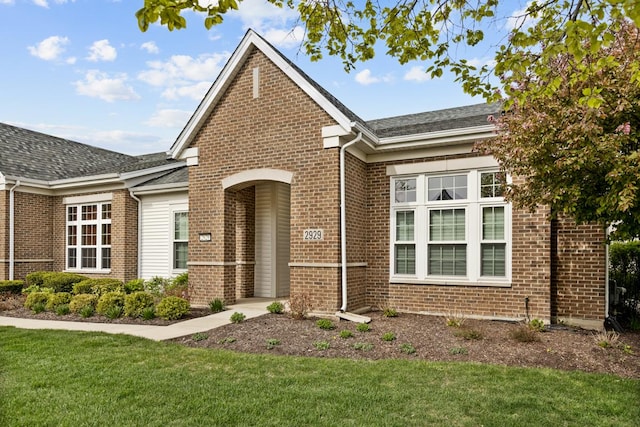2929 Portage St, Naperville, IL 60564 - view of front of house featuring brick siding, a front lawn, and roof with shingles