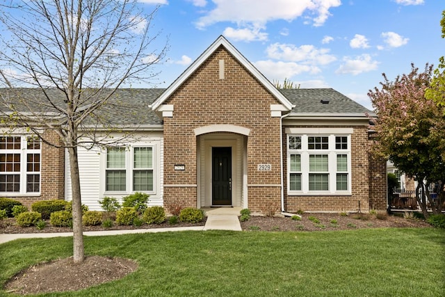 2929 Portage St, Naperville, IL 60564 - traditional-style house with brick siding, a front lawn, and a shingled roof