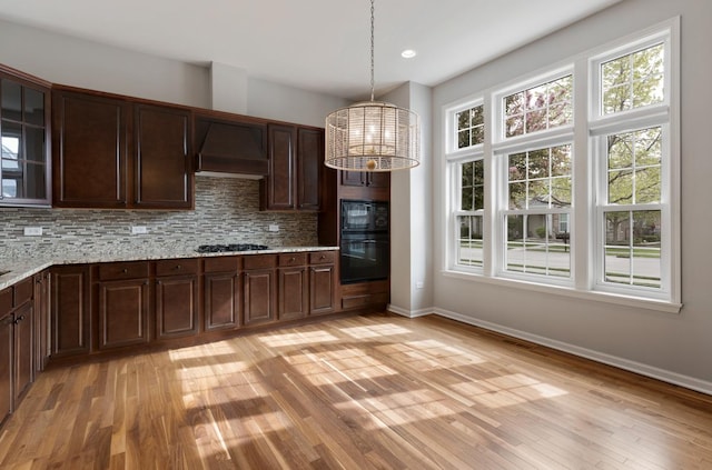 2929 Portage St, Naperville, IL 60564 - kitchen featuring premium range hood, a chandelier, black appliances, backsplash, and light wood-style flooring