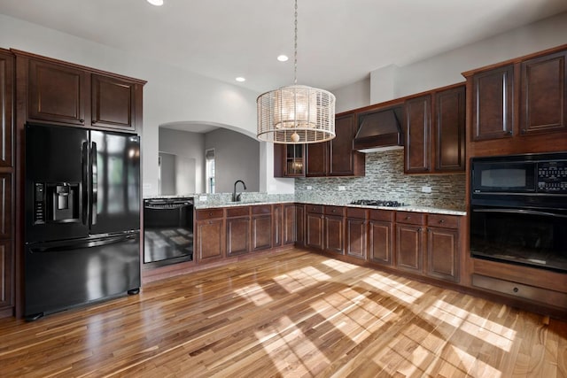 2929 Portage St, Naperville, IL 60564 - kitchen with black appliances, premium range hood, light wood-style flooring, dark brown cabinets, and recessed lighting