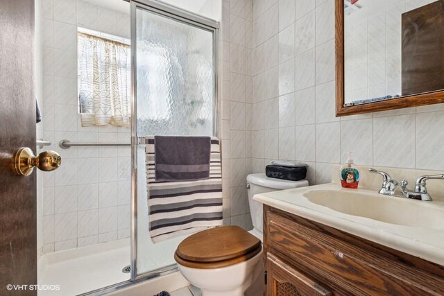 9133 Moody Ave, Oak Lawn, IL 60453 - full bathroom with tile walls, vanity, and a shower stall