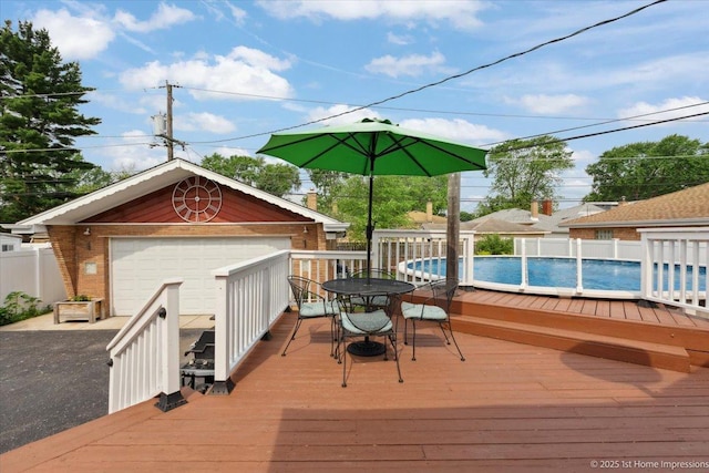 9122 S Avers Ave, Evergreen Park, IL 60805 - wooden deck with outdoor dining area, an outbuilding, and a detached garage