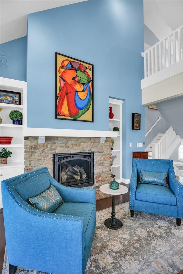 2955 E Stone Creek Blvd, Urbana, IL 61802 - living room featuring wood finished floors, a fireplace, built in shelves, and stairway