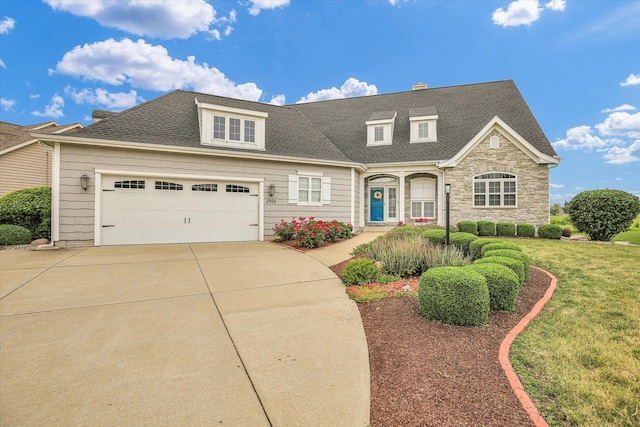 2955 E Stone Creek Blvd, Urbana, IL 61802 - traditional-style house with driveway, stone siding, a front lawn, and a shingled roof