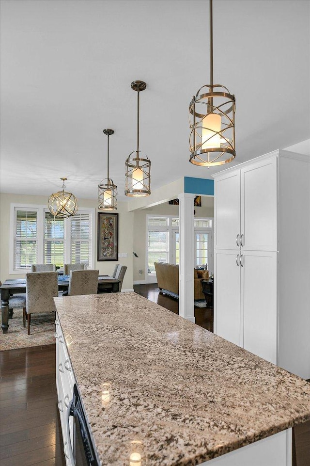 2955 E Stone Creek Blvd, Urbana, IL 61802 - kitchen featuring white cabinetry, light stone countertops, dark wood-type flooring, and pendant lighting