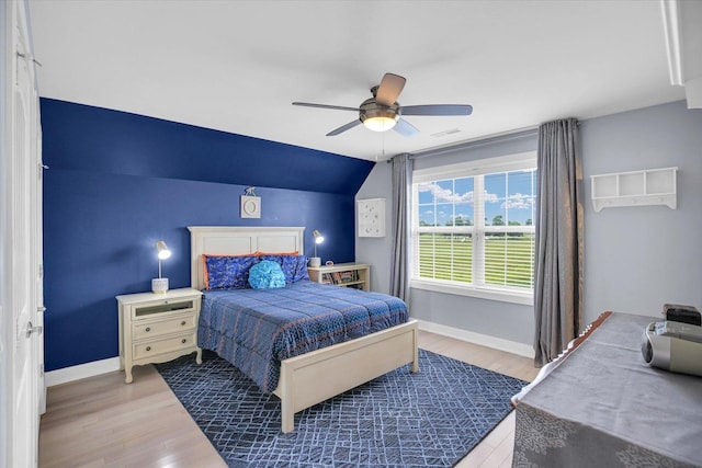 2955 E Stone Creek Blvd, Urbana, IL 61802 - bedroom with vaulted ceiling, wood finished floors, and a ceiling fan