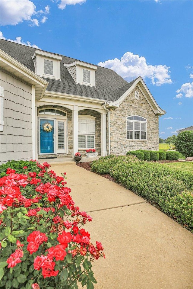 2955 E Stone Creek Blvd, Urbana, IL 61802 - entrance to property with stone siding and a shingled roof