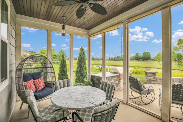 2955 E Stone Creek Blvd, Urbana, IL 61802 - sunroom featuring ceiling fan and view of golf course