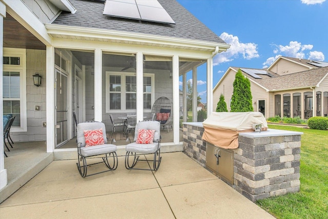 2955 E Stone Creek Blvd, Urbana, IL 61802 - view of patio with a sunroom, an outdoor kitchen, and outdoor dining area