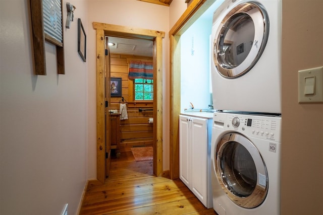 13153 E 1920 N Rd, Pontiac, IL 61764 - washroom with estacked washer and dryer, cabinet space, and light wood-type flooring