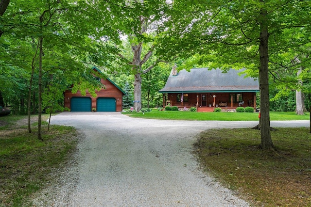 13153 E 1920 N Rd, Pontiac, IL 61764 - log home with covered porch, a garage, curved driveway, an outbuilding, and a front lawn