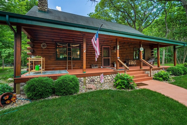 13153 E 1920 N Rd, Pontiac, IL 61764 - back of property featuring covered porch, log siding, a chimney, and a lawn