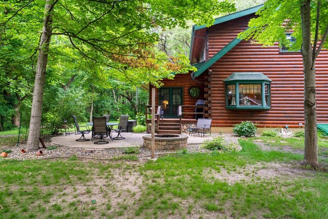 13153 E 1920 N Rd, Pontiac, IL 61764 - back of house with a patio, a fire pit, and log siding