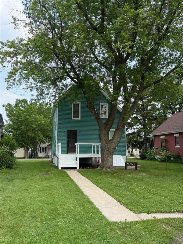 rear view of property featuring a yard