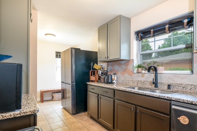 2417 Lyons St, Evanston, IL 60201 - kitchen with freestanding refrigerator, dishwasher, light tile patterned floors, decorative backsplash, and gray cabinetry