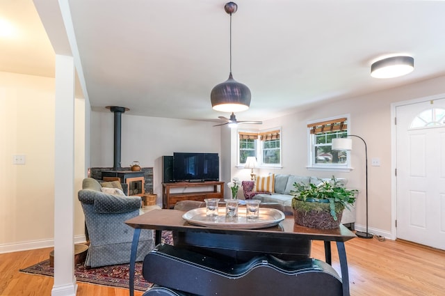 2417 Lyons St, Evanston, IL 60201 - living area with a wood stove, light wood finished floors, and a ceiling fan