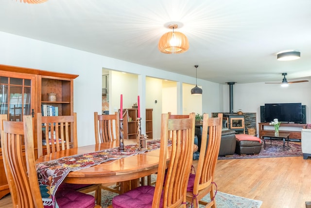 2417 Lyons St, Evanston, IL 60201 - dining room with a ceiling fan, a wood stove, and wood finished floors