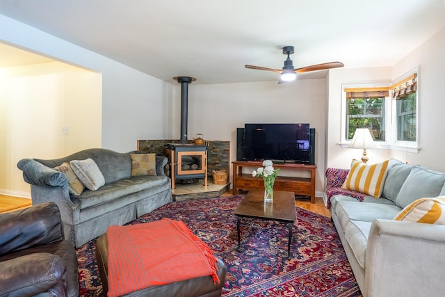 2417 Lyons St, Evanston, IL 60201 - living area featuring a wood stove, a ceiling fan, and wood finished floors