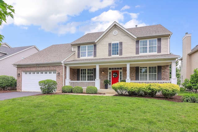 606 Ebony Dr, Oswego, IL 60543 - view of front of property with a porch, brick siding, asphalt driveway, an attached garage, and a front yard