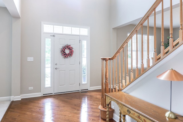 606 Ebony Dr, Oswego, IL 60543 - foyer featuring a towering ceiling, stairs, and wood finished floors