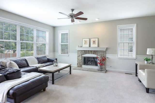 606 Ebony Dr, Oswego, IL 60543 - carpeted living area featuring ceiling fan and a stone fireplace