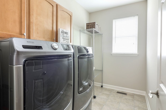 606 Ebony Dr, Oswego, IL 60543 - laundry room with washing machine and clothes dryer and cabinet space