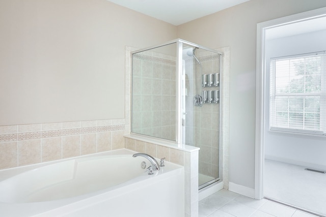 606 Ebony Dr, Oswego, IL 60543 - bathroom with a garden tub, a stall shower, and tile patterned flooring