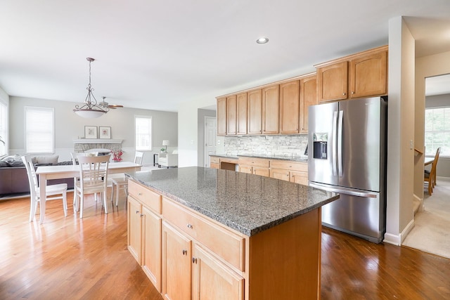 606 Ebony Dr, Oswego, IL 60543 - kitchen featuring stainless steel refrigerator with ice dispenser, dark wood-style flooring, healthy amount of natural light, a kitchen island, and recessed lighting