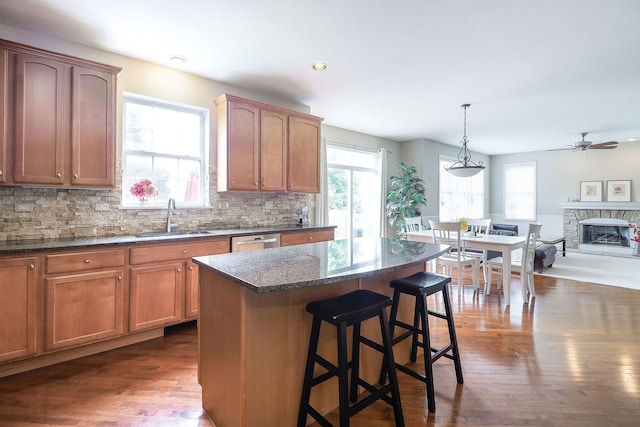 606 Ebony Dr, Oswego, IL 60543 - kitchen with dark wood-type flooring, healthy amount of natural light, tasteful backsplash, a breakfast bar, and recessed lighting